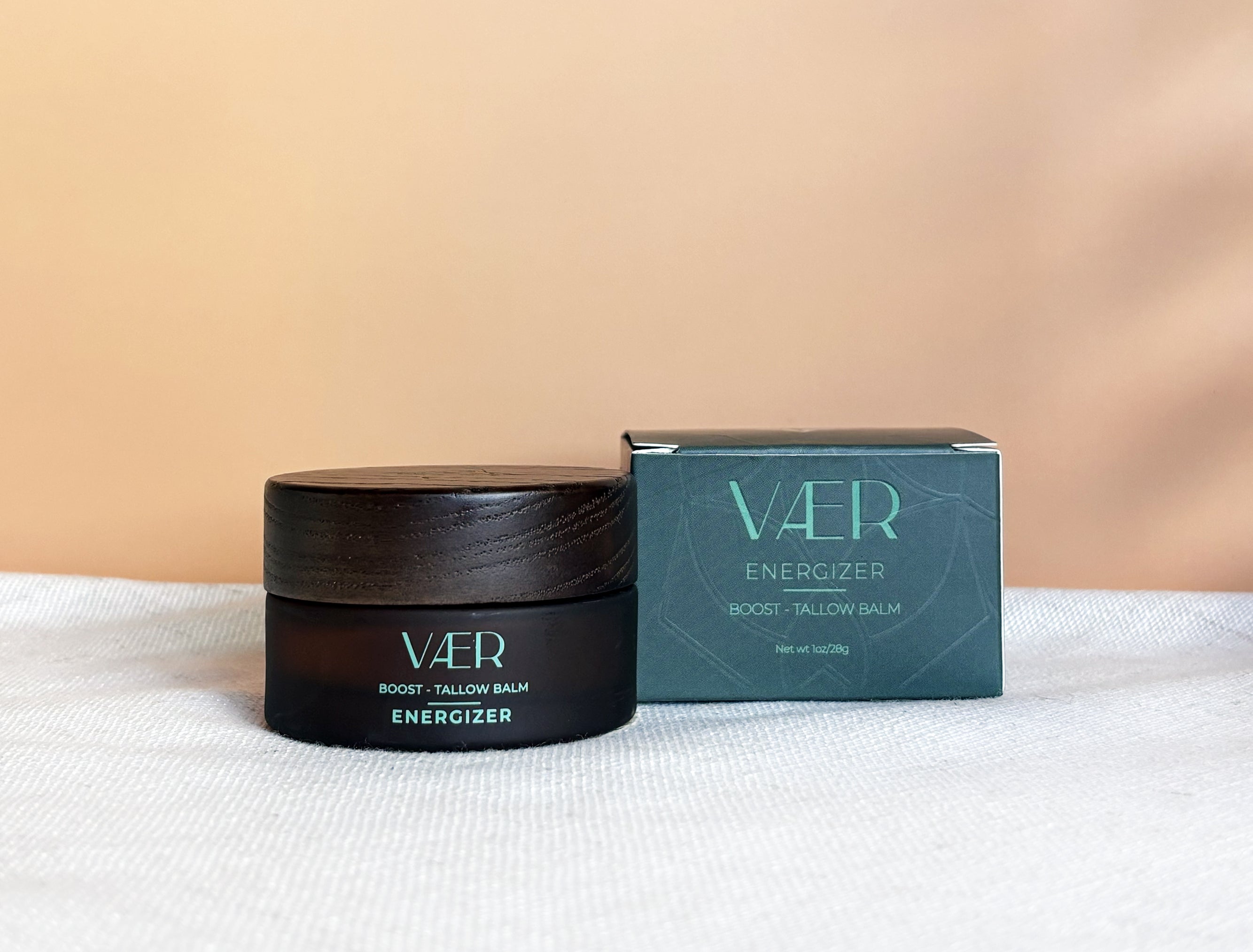 VAER Energizer balm jar and box on a white surface with beige background