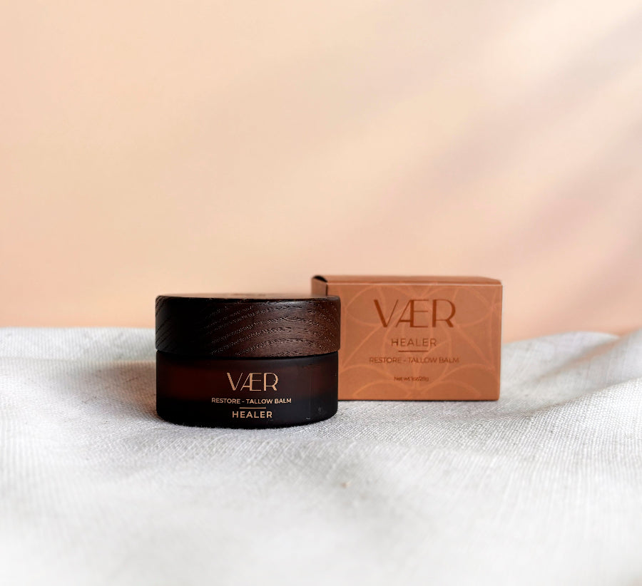 VAER Healer balm jar and box on a white surface with a beige background
