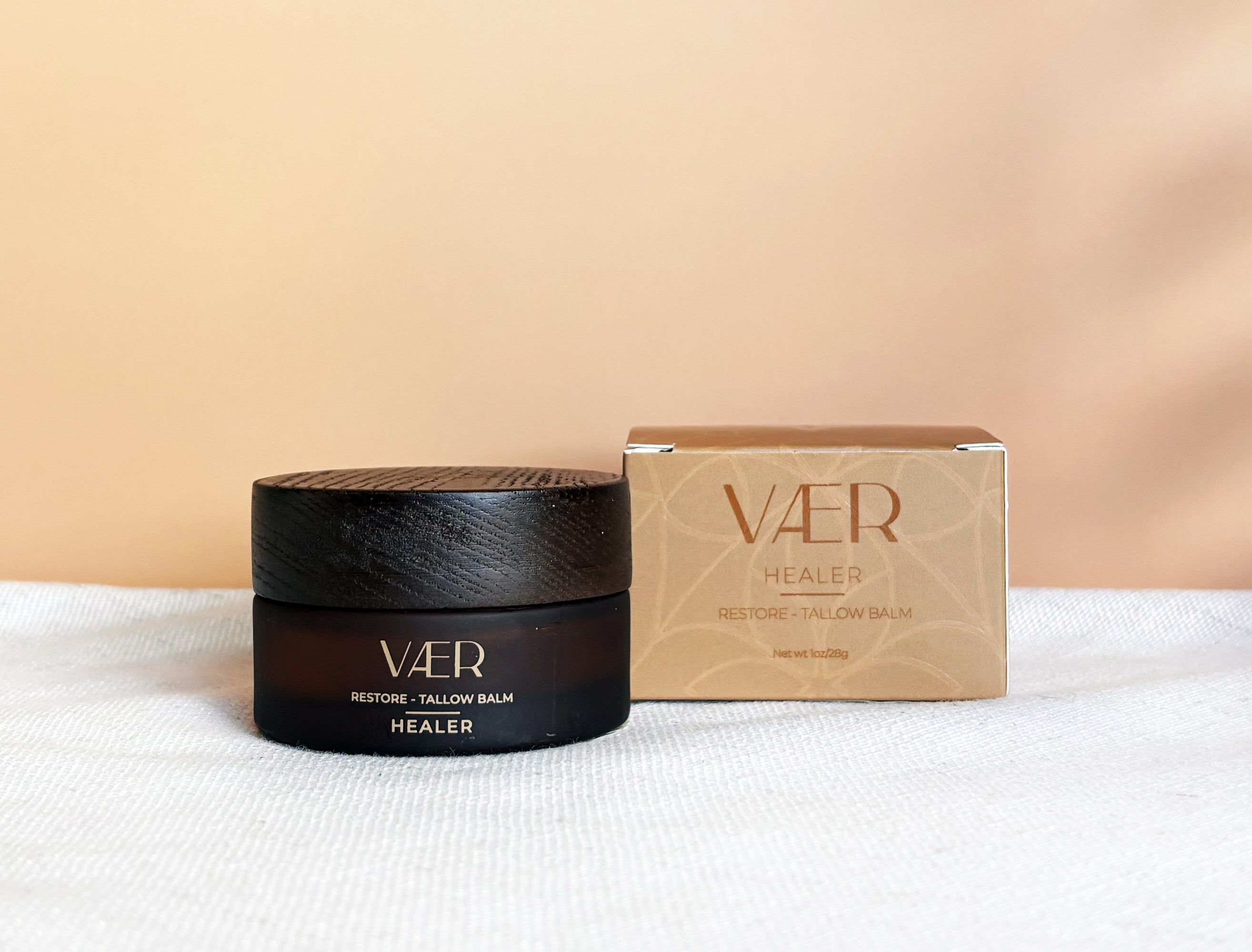VAER balm jar and box on a white surface with a beige background